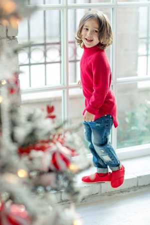 Portrait of a charming boy at Christmas at home. Fashionable child. High quality photo.の写真素材