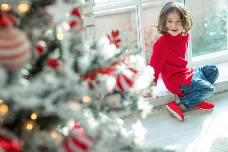 Portrait of a charming boy at Christmas at home. Fashionable child. High quality photo.の写真素材