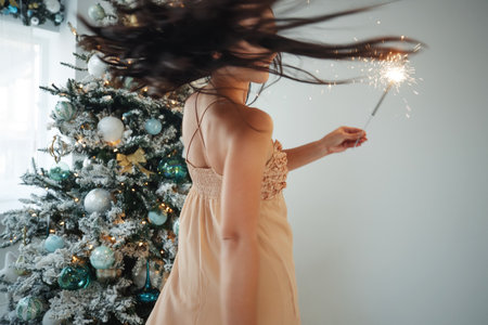 A woman with a sparkler at Christmas. High quality photo.の写真素材