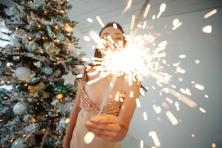 A woman with a sparkler at Christmas. High quality photo.の写真素材
