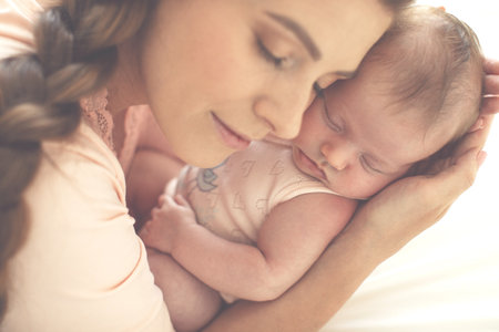 Portrait of a beautiful mother, with her nursing baby. High quality photo.の写真素材