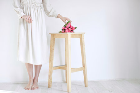 Female hands with tulips, the florist makes a bouquet. High quality photoの写真素材