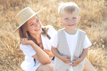 Mother and little child are playing together in the park. High quality photo.の写真素材