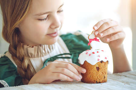 The child is holding an Easter cake. Birthday cake. High quality photo.の写真素材