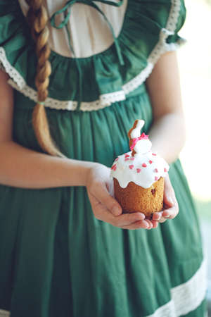 The child is holding an Easter cake. Birthday cake. High quality photo.の写真素材