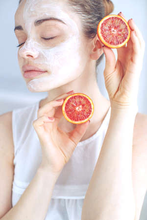 Woman with cosmetic mask on her face. The daily routine is facial cleansing, skin care, exfoliation, moisturizing. High quality photo.の写真素材