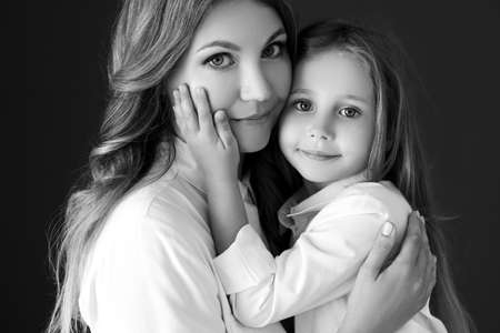 Mother child black white. Woman with child black and white photo. High quality photoの写真素材