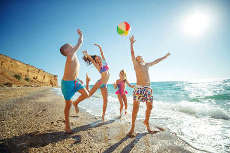 Cute kids having fun on the sandy beach in summer. High quality photo.の写真素材