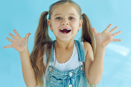 Portrait of preschooler girl with open mouth without milk tooth. High quality photoの写真素材