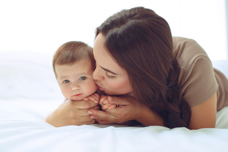 A young mother is holding her newborn baby. Mother of a nursing baby. Mother breastfeeding her baby. The family is at home. Portrait of a happy mother and child. High quality photo.の写真素材