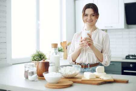 Woman food. Young woman in the kitchen at home. High quality photo.の写真素材