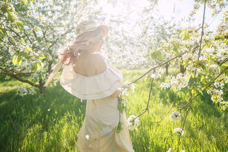 Woman in the spring. Beautiful and fashionable woman in the spring in the garden. High quality photo.の写真素材