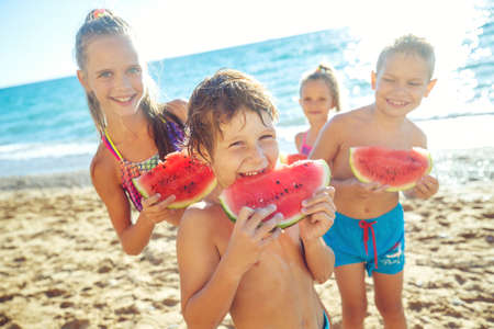 Happy child on the sea with watermelon. High quality photoの写真素材