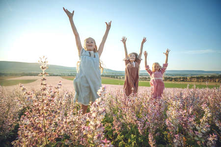 Happy child jumping high in nature. Children play in the open air. High quality photoの写真素材