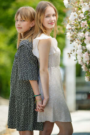 Girlfriend sisters hug in nature. High quality photoの写真素材