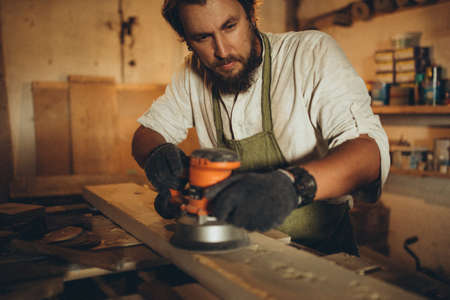 A male joiner works in the workshop. High quality photoの写真素材