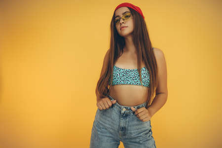 The teenage girl is fashionable. Young girl posing in the studio. High quality photoの写真素材