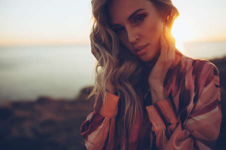Beautiful woman. Young woman, sunlight, sunset. High quality photoの写真素材
