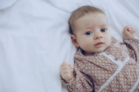 The baby is lying on the bed. High quality photoの写真素材