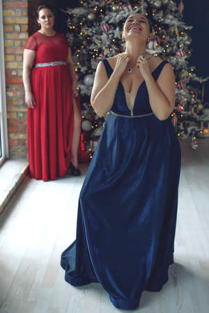 Woman at Christmas. Fat woman in a beautiful dress for a holiday. High quality photoの写真素材