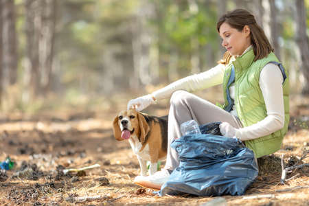 A woman removes rubbish in nature. High quality photoの写真素材