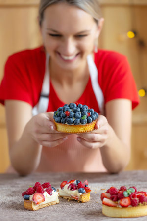 A pastry chef in the kitchen, baking tartlets and pastries. High quality photoの写真素材