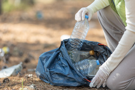 A woman removes rubbish in nature. High quality photoの写真素材