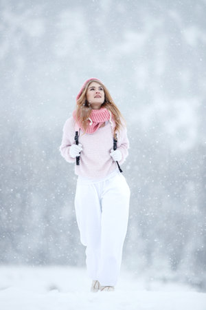 Woman in the winter in nature. A beautiful girl walks in the cold season. High quality photoの写真素材