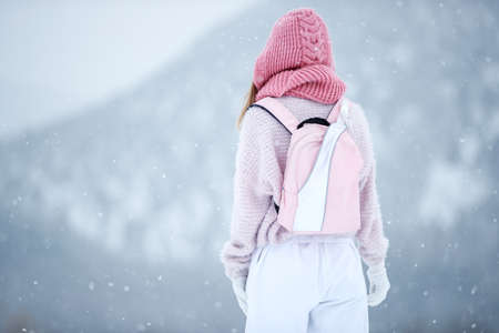 Woman in the winter in nature. A beautiful girl walks in the cold season. High quality photoの写真素材