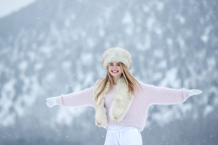 Woman in the winter in nature. A beautiful girl walks in the cold season. High quality photoの写真素材