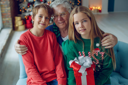 Children give grandfathers a present for Christmas. High quality photo