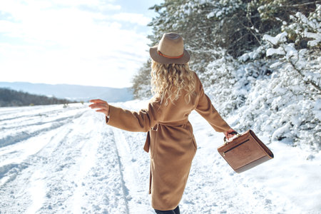 Woman travels in winter. Beautiful girl in the winter in nature. High quality photoの写真素材