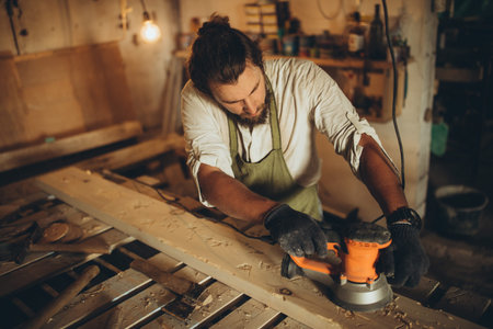 A male joiner works in the workshop. High quality photoの写真素材