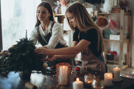 A woman makes a Christmas tree with her own hands. High quality photoの写真素材