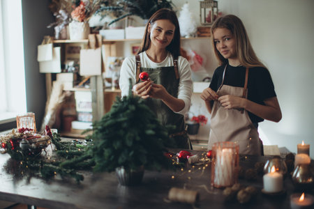 A woman makes a Christmas tree with her own hands. High quality photoの写真素材