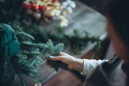A woman makes a Christmas tree with her own hands. High quality photoの写真素材
