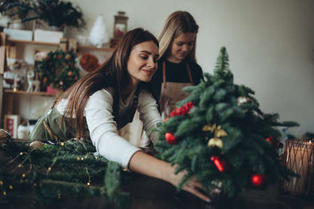 A woman makes a Christmas tree with her own hands. High quality photoの写真素材