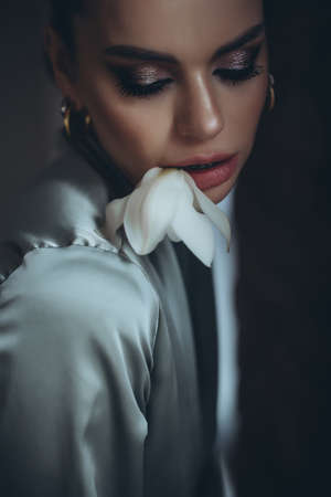 Woman with a flower in the studio. High quality photoの写真素材