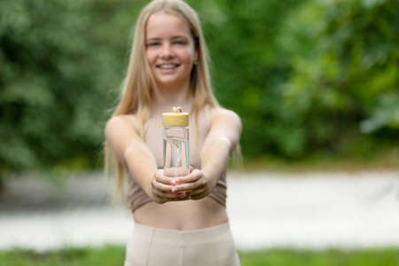 Drink water. Young girl with a bottle of water. High quality photoの写真素材