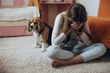 Teenage girl in depression in her room. High quality photoの写真素材
