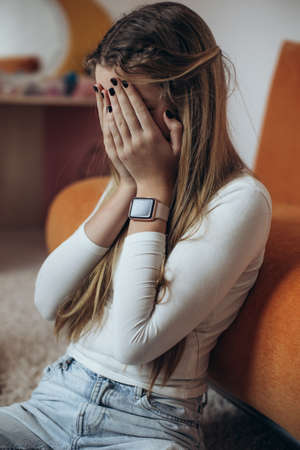 Teenage girl in depression in her room. High quality photoの写真素材