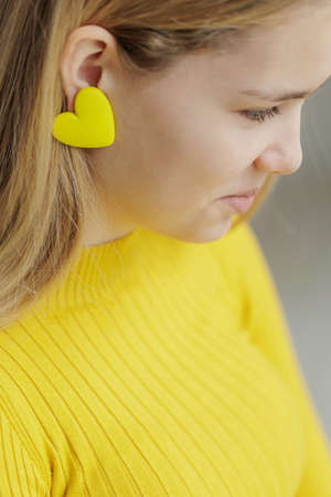 Teenage girl chooses jewelry earrings. Heart shaped earrings. St. Valentines Day. High quality photoの写真素材