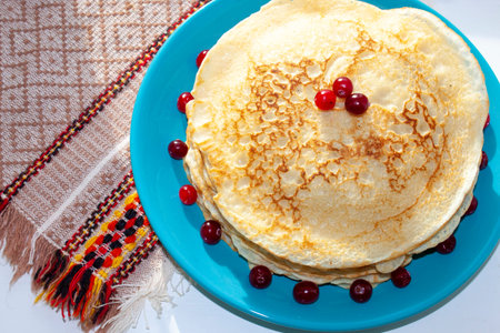 Homemade pancakes decorated with cranberry berries. Sweet food. Rustic