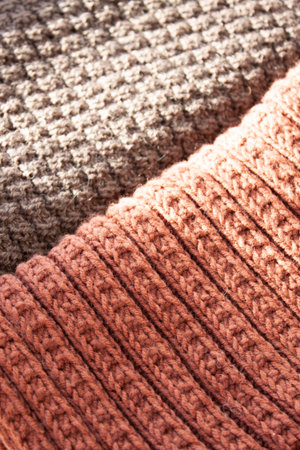 Knitting. Knitted scarf. Brown scarf. Hoby. Material background