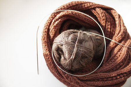 Hoby. Knitting. Knitted snood scarf from a skein of yarn and circular knitting needlesの写真素材