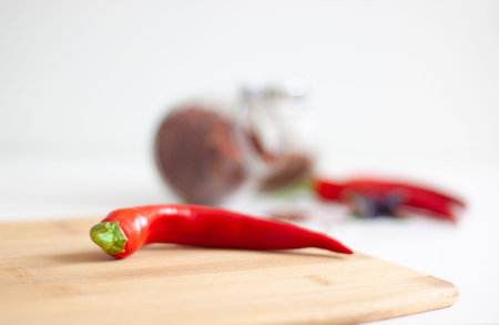Hot red pepper in the foreground. Spices in the background. Cooking, ingredients