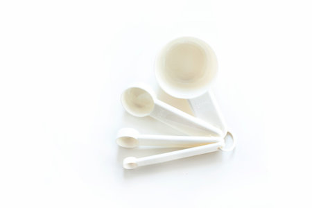 White measuring spoons on a white backgroundの写真素材