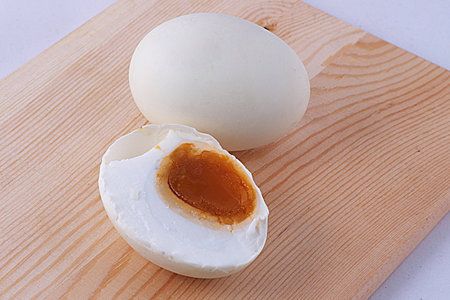 Salted boiled egg   in a half on wooden boardの素材