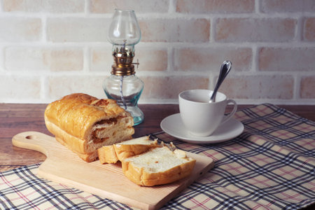 Picture of Bread stuffing with pork and coffee cup on vintage backgroundの写真素材