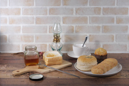 Picture of bakeries on the wooden table and brickwall in vintage styleの写真素材